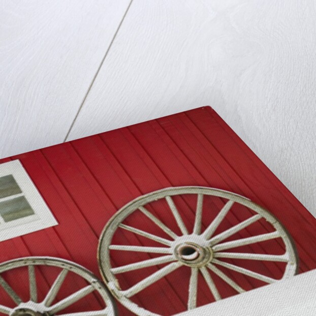Wagon Wheels on Snow Against Stable by Anonymous