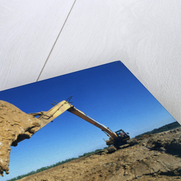 Backhoe Working in Muddy Field by Anonymous