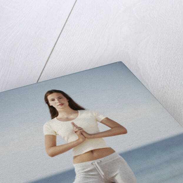 Woman doing yoga by the ocean by Anonymous