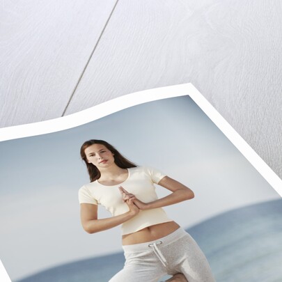 Woman doing yoga by the ocean by Anonymous
