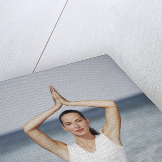 Woman meditating in the ocean by Anonymous