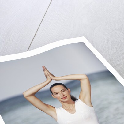 Woman meditating in the ocean by Anonymous