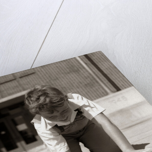 1950s Boy Ready To Shoot Kneeling On School Yard Ground Playing Game Of Marbles by Anonymous