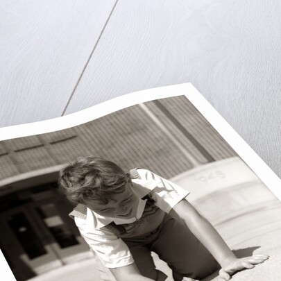 1950s Boy Ready To Shoot Kneeling On School Yard Ground Playing Game Of Marbles by Anonymous