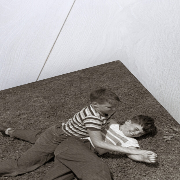 1950s Two Boys Wear Tee Shirts Blue Jeans Playing Rough Fighting Wrestling On The Grass by Anonymous