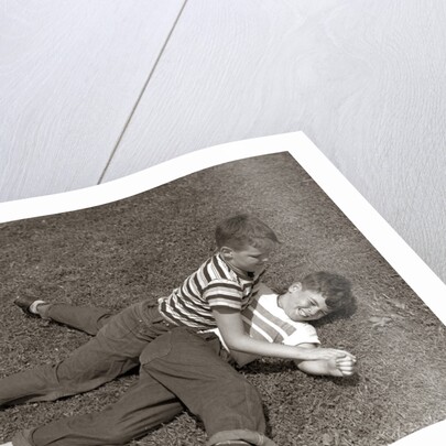 1950s Two Boys Wear Tee Shirts Blue Jeans Playing Rough Fighting Wrestling On The Grass by Anonymous