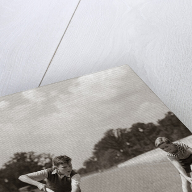 1930s 1940s 2 Boys With Sticks And Puck Wearing Roller Skates Playing Street Hockey by Anonymous