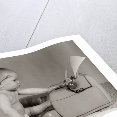 1960s Businesslike Baby With Pencil Behind Ear Typing On Typewriter by Anonymous
