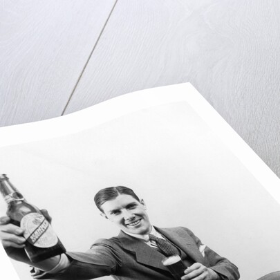 1920s 1930s Man Holding Up Huge Distorted Beer Bottle In One Hand And A Regular Size Glass Of Beer In Other by Anonymous