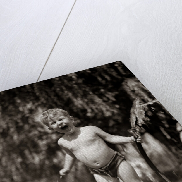 1940s 1950s Wet Young Boy Toddler Outside Playing With Water Hose by Anonymous