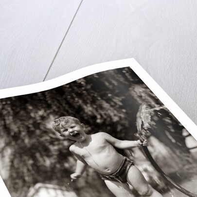 1940s 1950s Wet Young Boy Toddler Outside Playing With Water Hose by Anonymous