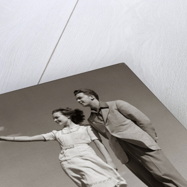 1940s Teenage Couple Standing Together Outdoors Girl Pointing by Anonymous