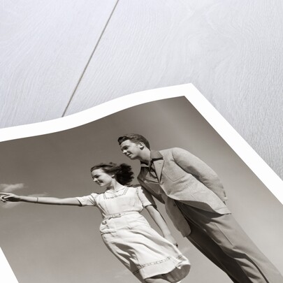 1940s Teenage Couple Standing Together Outdoors Girl Pointing by Anonymous