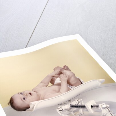 1950s 1960s Baby Lying On Weight Scale by Anonymous