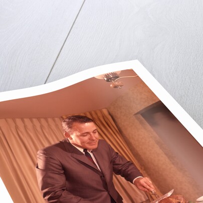 1960s Well-Dressed Man Carving Roast Beef At Dinner Table by Anonymous