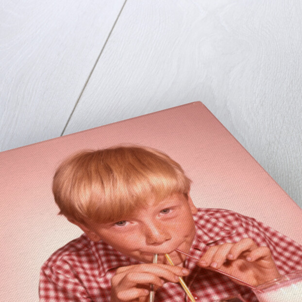 1950s 1960s Boy Drinking Three Milkshakes Through A Straw At Same Time by Anonymous