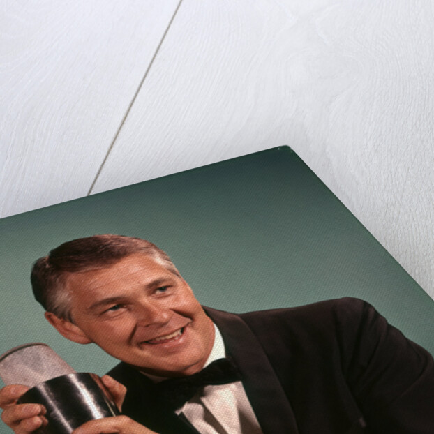 1960s 1970s Bartender Man In Black Tuxedo Mixing Cocktail In Shaker by Anonymous