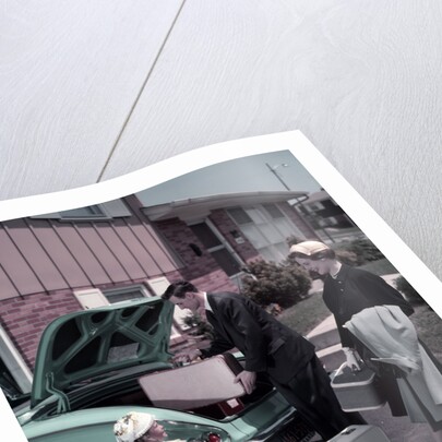 1950s Family Mother Father Daughter In Front Of Suburban House Packing Luggage In Car For Vacation by Anonymous