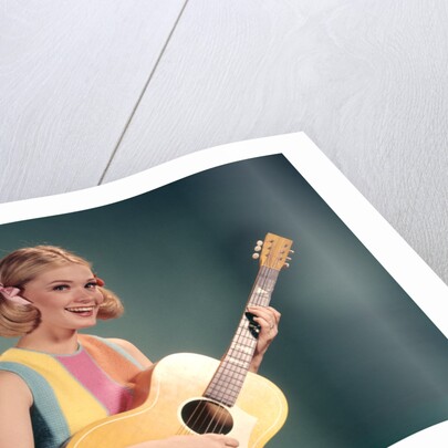1960s Perky Young Teenager Folk Singer Playing Guitar by Anonymous