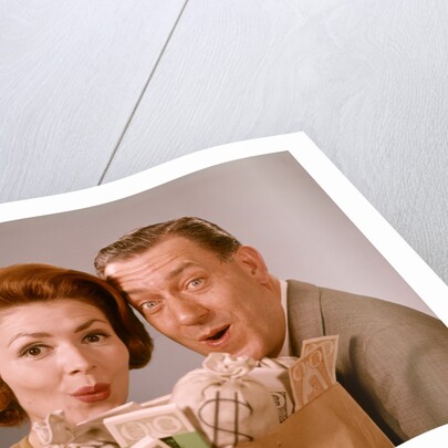 1960s Surprised Happy Couple Man Woman With Grocery Bag Filled With Money by Anonymous