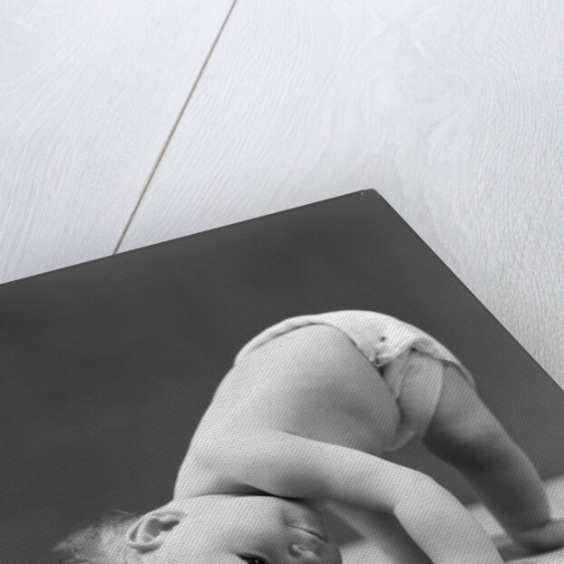 1940s Baby Bending Down With Head On Blanket by Anonymous