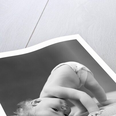 1940s Baby Bending Down With Head On Blanket by Anonymous