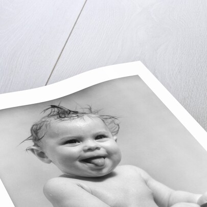 1940s 1930s Wet Baby Sitting In Tub Sticking Out Tongue by Anonymous