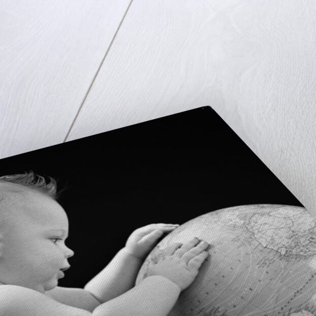 1940s Baby With Hands On Globe Looking At The Earth by Anonymous