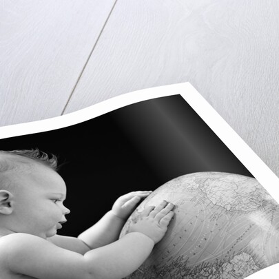 1940s Baby With Hands On Globe Looking At The Earth by Anonymous