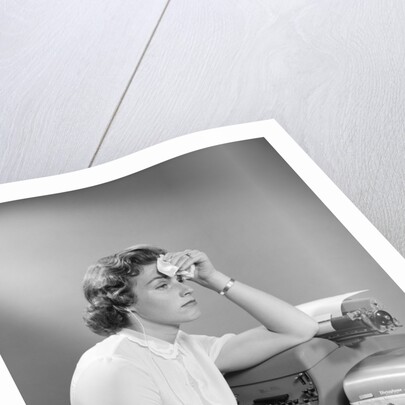 1950s Ailing Secretary Sitting At Desk With Typewriter And Dictation Machine Holding Handkerchief To Forehead by Anonymous