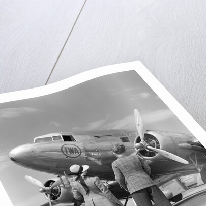1940s Rear View Of Boy and Girl Standing Together Looking At Propeller Airplane Outdoor by Anonymous