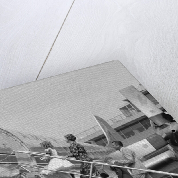 1950s Family Boarding Propeller Airliner By Climbing Gangway Stairs At Airport by Anonymous