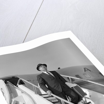 1960s Businessman Deplaning From Airplane Wearing Hat And Carrying Overcoat And Briefcase by Anonymous