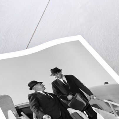 1960s Two Business Men Briefcase Exit Airplane Steps by Anonymous