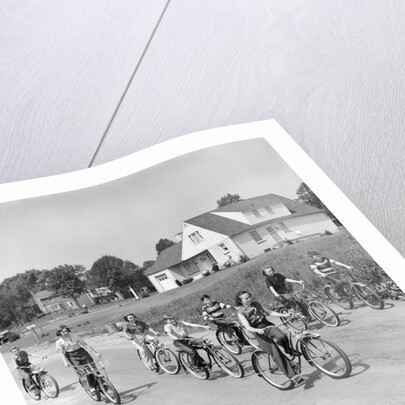 1950s 8 Kids Boys and Girls Ride Bicycles On Country Rural Road Lane Fun House In Background by Anonymous