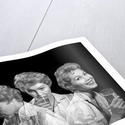 1950s 1960s Woman With A Headache Taking Medicine And With Expression Of Relief From Pain by Anonymous