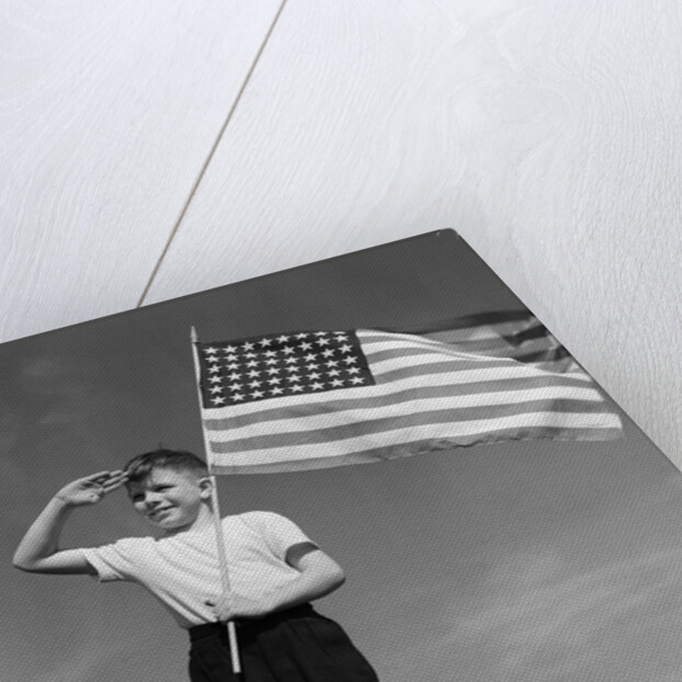 1940s Boy Holding American Flag Saluting Wearing Short Pants by Anonymous