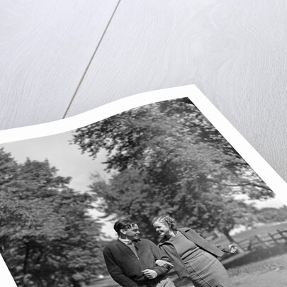 1930s 1940s Young Teen Couple Boy Girl Strolling Down Autumn Country Lane Arm In Arm by Anonymous