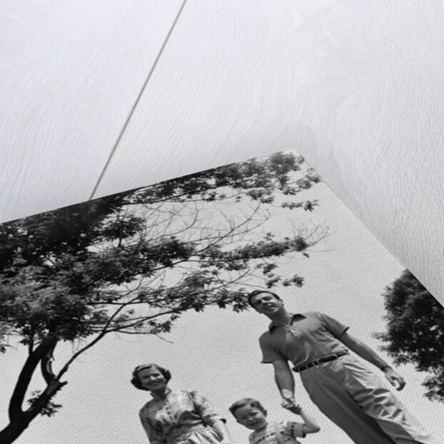 1950s Happy Family Mother Father Daughter Son Walking In Park by Anonymous