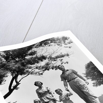 1950s Happy Family Mother Father Daughter Son Walking In Park by Anonymous