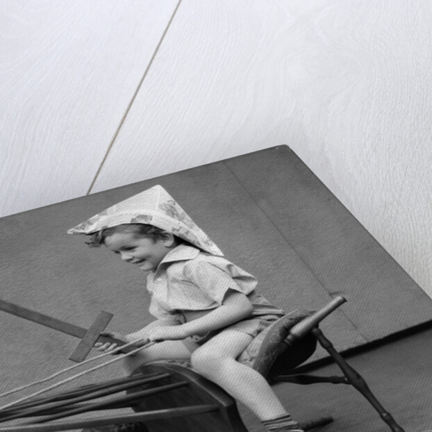 1930s Boy Playing Wooden Sword Paper Hat Riding Chair Like A Horse by Anonymous