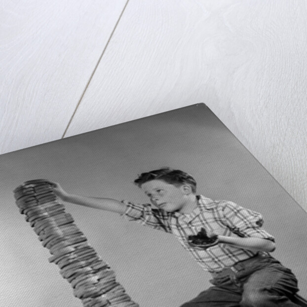 1950s Boy Eating Jelly Toast Sitting On Ladder Stacking Up Tall Pile Of Toast From Toaster by Corbis