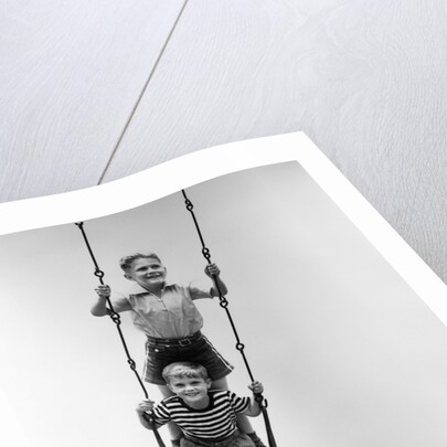 1930s Two Boys Sitting Standing On Playground Swing by Anonymous
