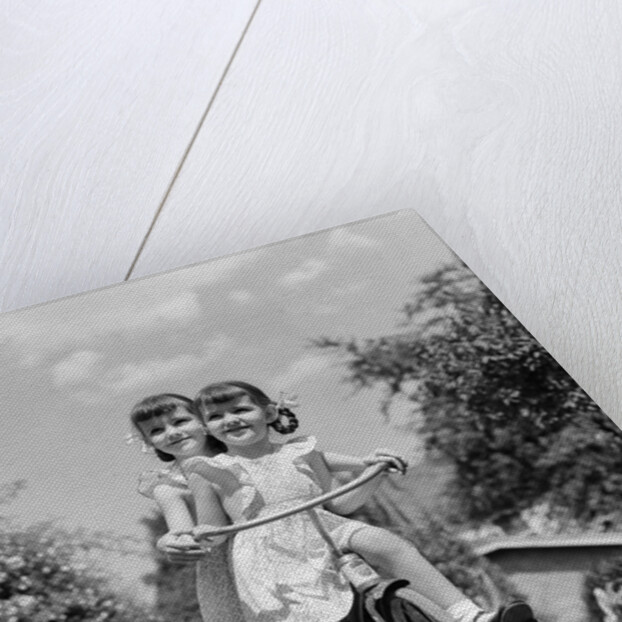 1940s Twin Girls Riding Outside On Tricycle by Anonymous