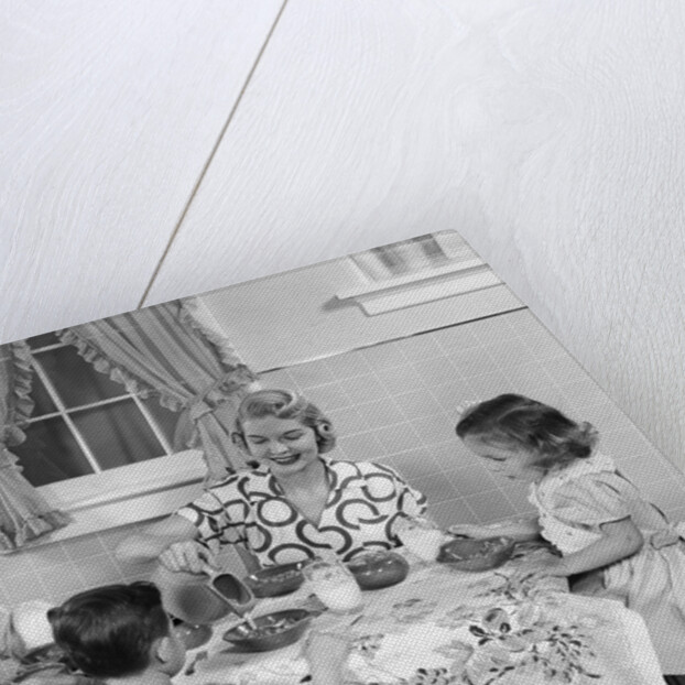1950s Family Sitting At Kitchen Table Having Breakfast by Anonymous