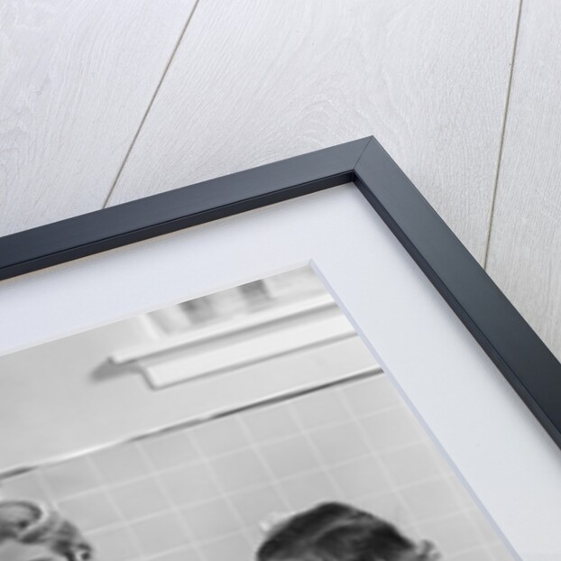 1950s Family Sitting At Kitchen Table Having Breakfast by Anonymous