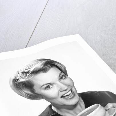 1960s Woman Drinking Coffee Holding Cup And Saucer by Anonymous