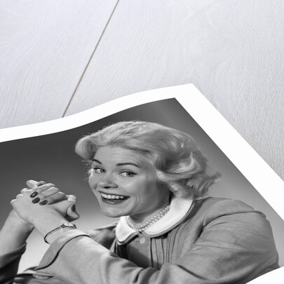 1950s 1960s Woman Making Winning Symbolic Hand Gesture With Raised Clasped Hands by Anonymous