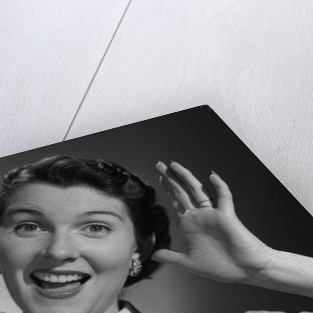 1950s Happy Woman Holding Hands Up Beside Her Head by Anonymous