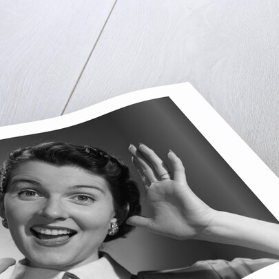 1950s Happy Woman Holding Hands Up Beside Her Head by Anonymous